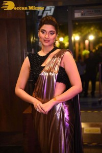 Saiee Manjrekar attending Ghani movie function in a brown shiny saree