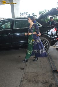 actress Sanya Malhotra in a green and blue dress