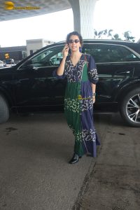 actress Sanya Malhotra in a green and blue dress