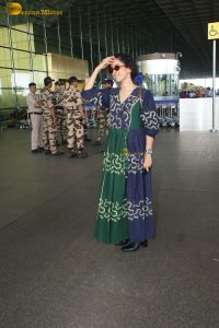 actress Sanya Malhotra in a green and blue dress