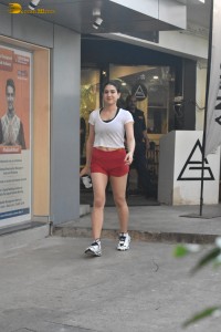 actress Sara Ali Khan in a white top and red shorts