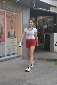 actress Sara Ali Khan in a white top and red shorts