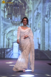 actress seerat kapoor in a white saree doing a ramp walk