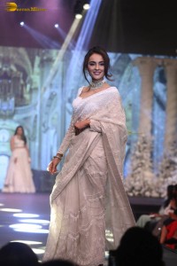 actress seerat kapoor in a white saree doing a ramp walk