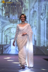 actress seerat kapoor in a white saree doing a ramp walk