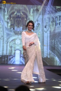 actress seerat kapoor in a white saree doing a ramp walk