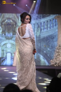 actress seerat kapoor in a white saree doing a ramp walk