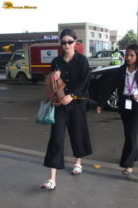 actress Shanaya Kapoor in black overalls at mumbai airport