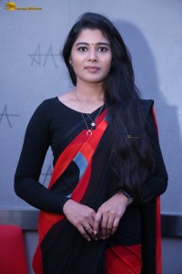 actress Sharanya Pradeep in a black and red saree at a movie event