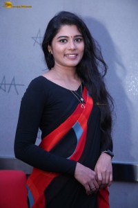actress Sharanya Pradeep in a black and red saree at a movie event