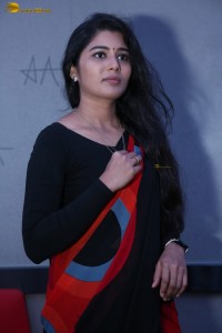 actress Sharanya Pradeep in a black and red saree at a movie event