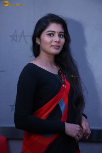 actress Sharanya Pradeep in a black and red saree at a movie event