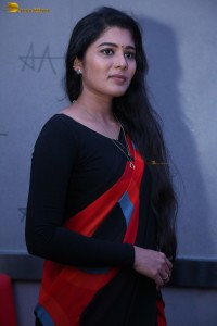 actress Sharanya Pradeep in a black and red saree at a movie event