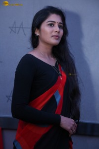 actress Sharanya Pradeep in a black and red saree at a movie event