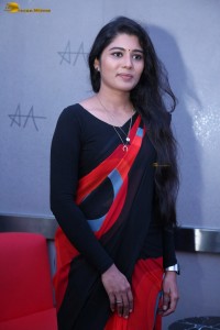 actress Sharanya Pradeep in a black and red saree at a movie event