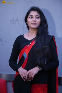 actress Sharanya Pradeep in a black and red saree at a movie event