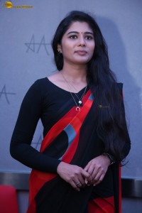 actress Sharanya Pradeep in a black and red saree at a movie event