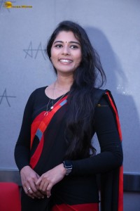 actress Sharanya Pradeep in a black and red saree at a movie event
