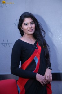 actress Sharanya Pradeep in a black and red saree at a movie event