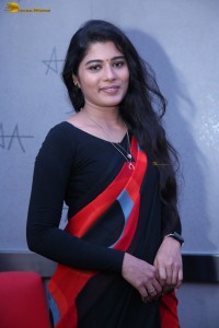 actress Sharanya Pradeep in a black and red saree at a movie event