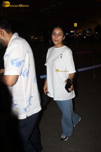 actress and singer Shehnaaz Gill in a white t-shirt and denim jeans at airport