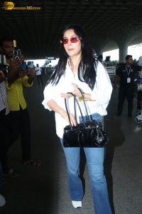 bollywood actress and singer shehnaaz gill cute in a white shirt and blue denim jeans at mumbai airport
