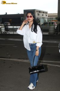 bollywood actress and singer shehnaaz gill cute in a white shirt and blue denim jeans at mumbai airport