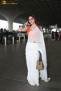 bollywood actress and playboy model sherlyn chopra spotted at mumbai airport in a white saree