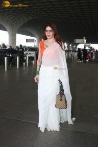 bollywood actress and playboy model sherlyn chopra spotted at mumbai airport in a white saree