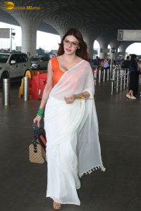 bollywood actress and playboy model sherlyn chopra spotted at mumbai airport in a white saree
