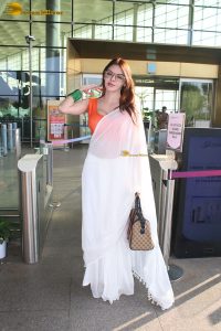 bollywood actress and playboy model sherlyn chopra spotted at mumbai airport in a white saree