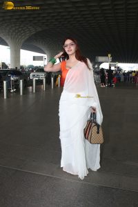 bollywood actress and playboy model sherlyn chopra spotted at mumbai airport in a white saree