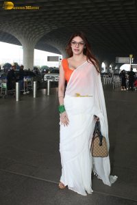bollywood actress and playboy model sherlyn chopra spotted at mumbai airport in a white saree