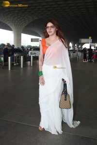 bollywood actress and playboy model sherlyn chopra spotted at mumbai airport in a white saree
