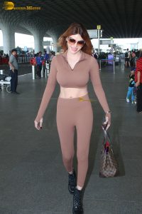 actress and playboy model Sherlyn Chopra in a brown dress at mumbai airport