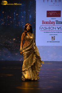 actress shilpa shetty beautiful in a golden saree doing a ramp walk