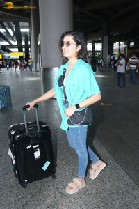singer and actress shirley setia in a green shirt and denim jeans at airport