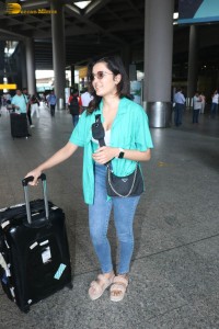 singer and actress shirley setia in a green shirt and denim jeans at airport