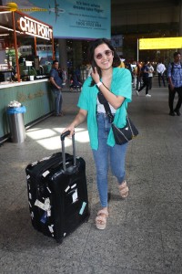 singer and actress shirley setia in a green shirt and denim jeans at airport
