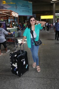 singer and actress shirley setia in a green shirt and denim jeans at airport