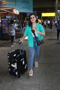 singer and actress shirley setia in a green shirt and denim jeans at airport