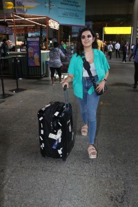 singer and actress shirley setia in a green shirt and denim jeans at airport