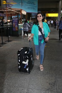 singer and actress shirley setia in a green shirt and denim jeans at airport