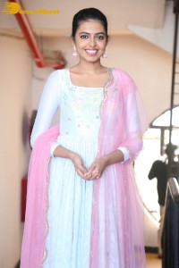 Shivani Rajashekar poses in a light colored Salwar Kameez dress