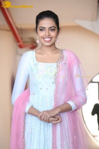 Shivani Rajashekar poses in a light colored Salwar Kameez dress
