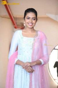 Shivani Rajashekar poses in a light colored Salwar Kameez dress