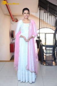 Shivani Rajashekar poses in a light colored Salwar Kameez dress