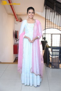 Shivani Rajashekar poses in a light colored Salwar Kameez dress