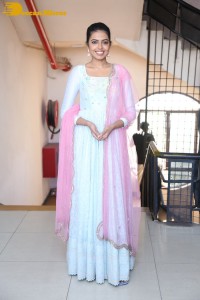 Shivani Rajashekar poses in a light colored Salwar Kameez dress