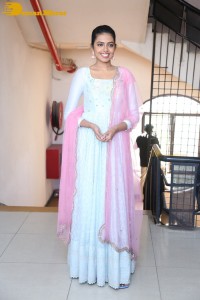 Shivani Rajashekar poses in a light colored Salwar Kameez dress